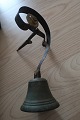 An antique bell used in a shop by the door
Bronce
The hanging is made by the iron 
About 1850