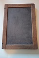 An old blackboard/slate mad of slate with an edge 
of wood