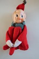 Gammel nisse, med armene omkring de foldede ben, 
som kan foldes ud
Oprindelig klokke i huen
H: ca. 12,5cm
Fra 1960-erne