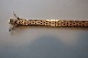 A rear bracelet of gold in a brick pattern
14 Karat, 5 rows
Decorated with a special ciselering/punchwork
Clasp with two safety catches too
L: 19,5cm
Stamp: ViGu 585
In a good condition